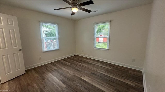 1004 Tabor St, High Point, NC 27262 - unfurnished room featuring healthy amount of natural light, dark wood-style floors, and baseboards