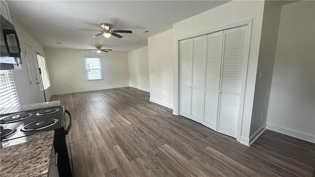 1004 Tabor St, High Point, NC 27262 - unfurnished living room with a ceiling fan, dark wood-style floors, and baseboards