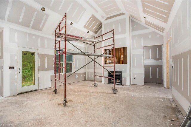 unfurnished living room featuring lofted ceiling