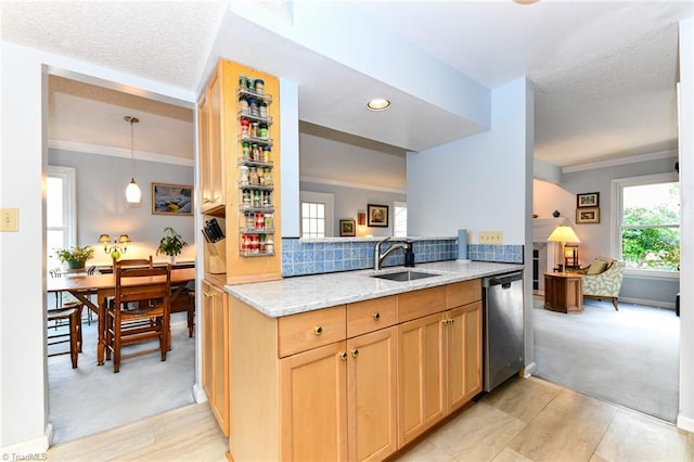 kitchen featuring sink, ornamental molding, dishwasher, light colored carpet, and light stone countertops