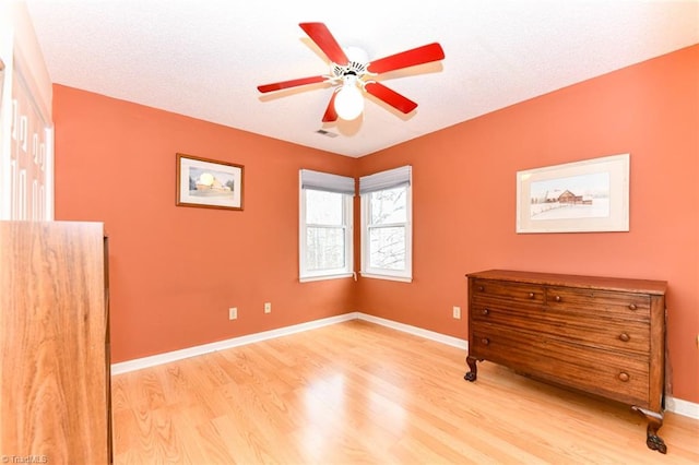 unfurnished bedroom featuring hardwood / wood-style flooring and ceiling fan