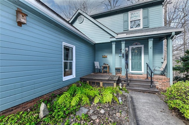 view of exterior entry featuring a porch