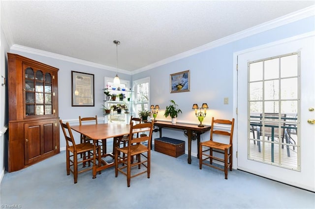 dining space with ornamental molding and light carpet