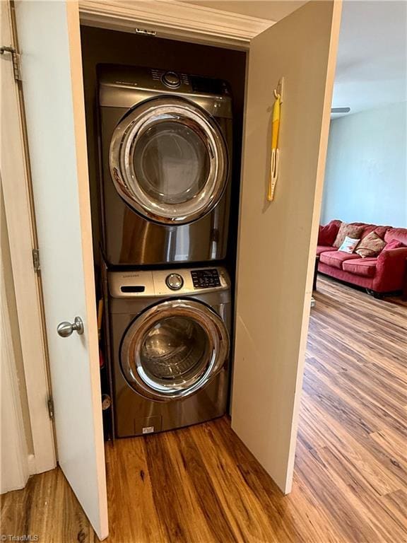 411 Washington St Unit 204, Greensboro, NC 27401 - washroom with estacked washer and dryer and wood finished floors
