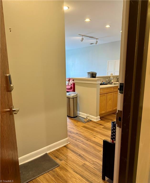 411 Washington St Unit 204, Greensboro, NC 27401 - hallway with light wood finished floors, baseboards, and recessed lighting