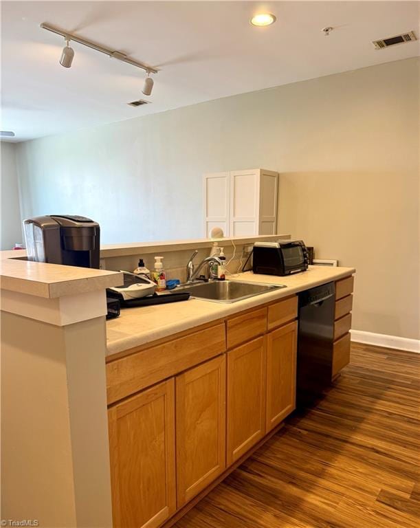 411 Washington St Unit 204, Greensboro, NC 27401 - kitchen featuring dishwasher, track lighting, dark wood-style floors, light countertops, and recessed lighting