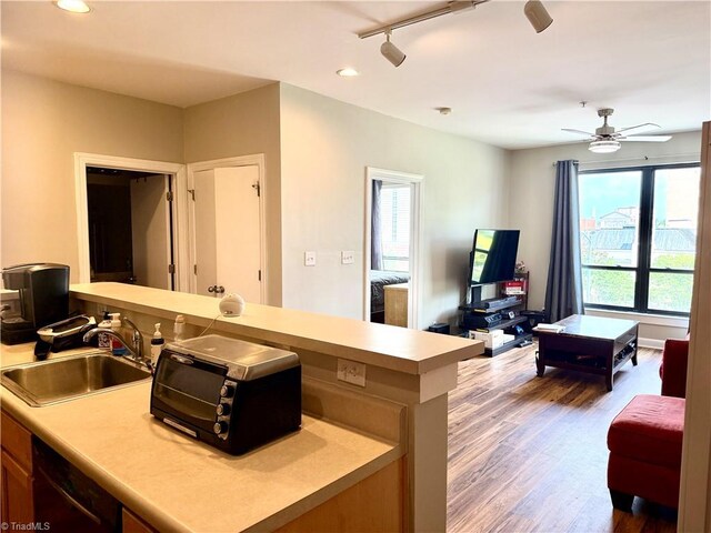 411 Washington St Unit 204, Greensboro, NC 27401 - kitchen featuring a sink, plenty of natural light, wood finished floors, light countertops, and recessed lighting