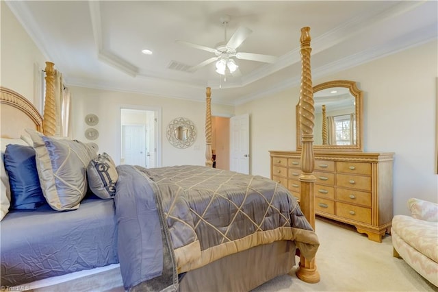 carpeted bedroom with ornamental molding, ceiling fan, and a tray ceiling