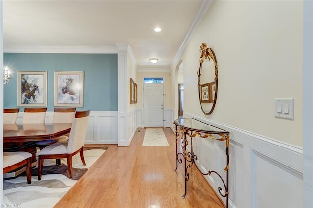 foyer featuring ornamental molding and light hardwood / wood-style floors