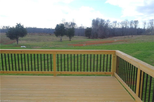 deck featuring a yard and a rural view