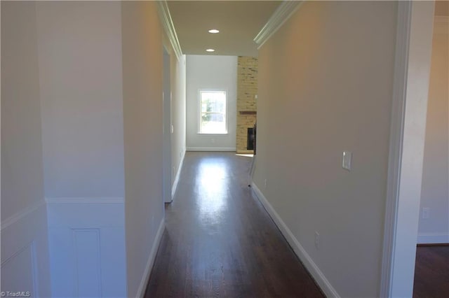 corridor featuring dark hardwood / wood-style flooring and crown molding