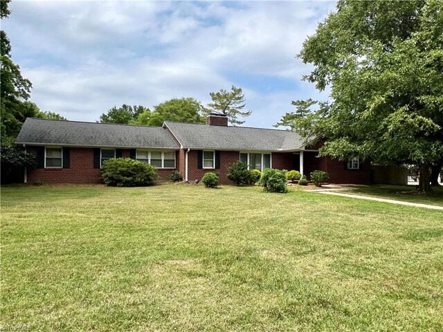 ranch-style house with a front lawn