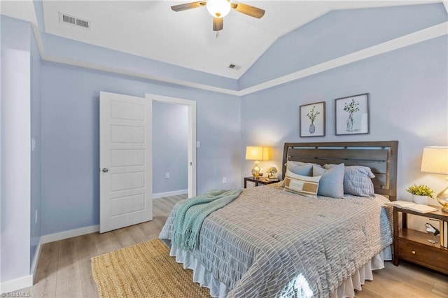 bedroom with ceiling fan, lofted ceiling, and light hardwood / wood-style flooring