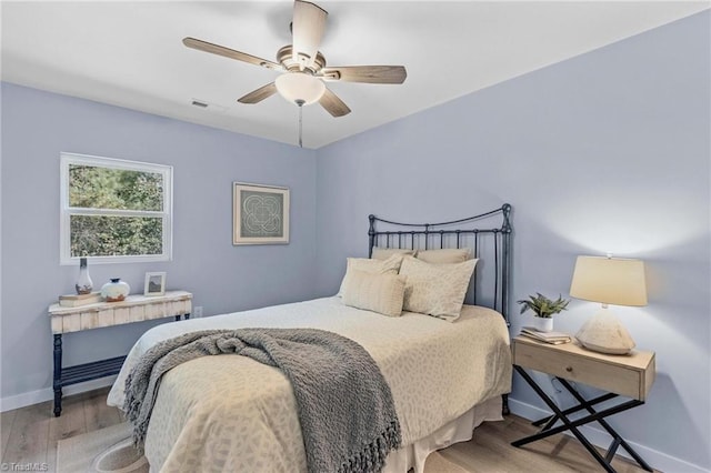 bedroom featuring light hardwood / wood-style flooring and ceiling fan