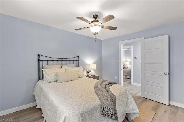 bedroom with light hardwood / wood-style floors and ceiling fan