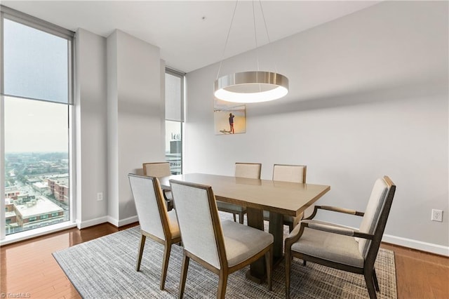 dining area featuring a healthy amount of sunlight and dark hardwood / wood-style flooring