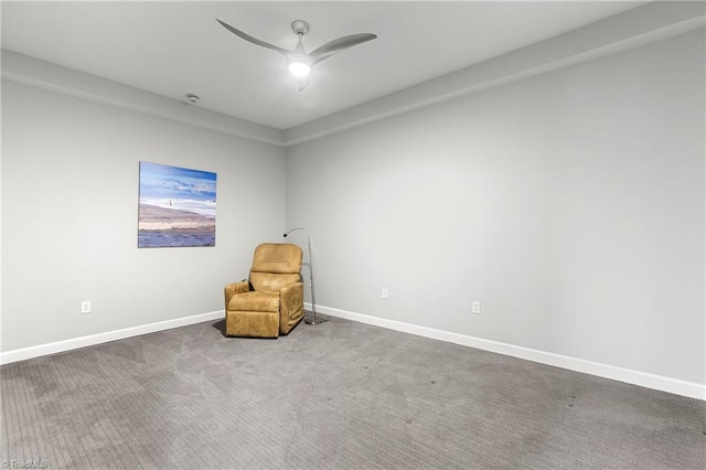 unfurnished room with ceiling fan and carpet