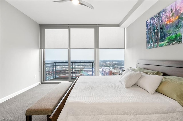 bedroom featuring carpet flooring, ceiling fan, and expansive windows