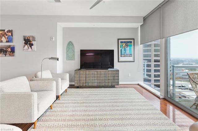 living room with hardwood / wood-style flooring and ceiling fan