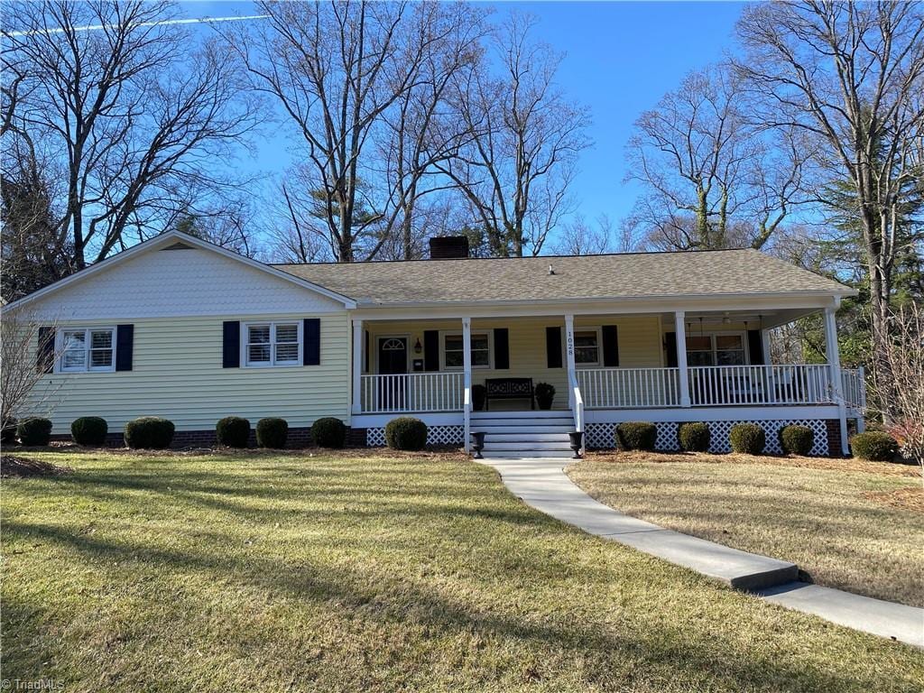 single story home with covered porch and a front lawn