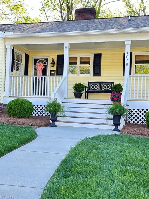 view of exterior entry featuring a porch