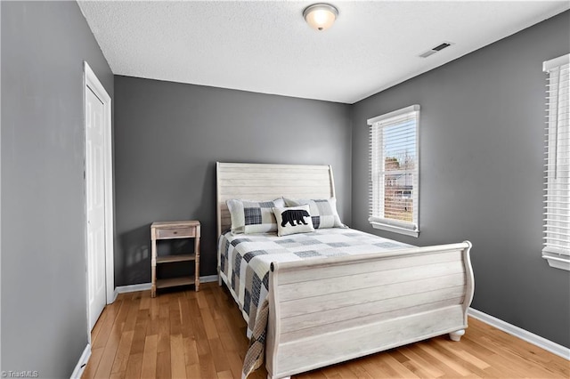 bedroom featuring wood-type flooring and a closet