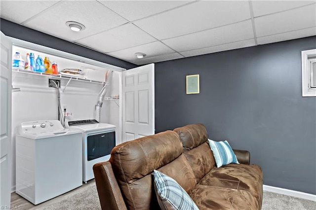 clothes washing area with separate washer and dryer and light carpet