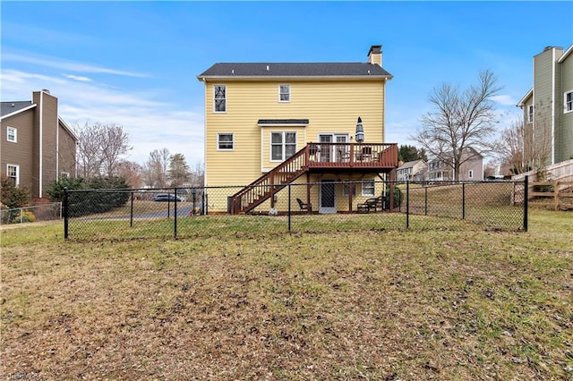 rear view of house featuring a yard and a deck