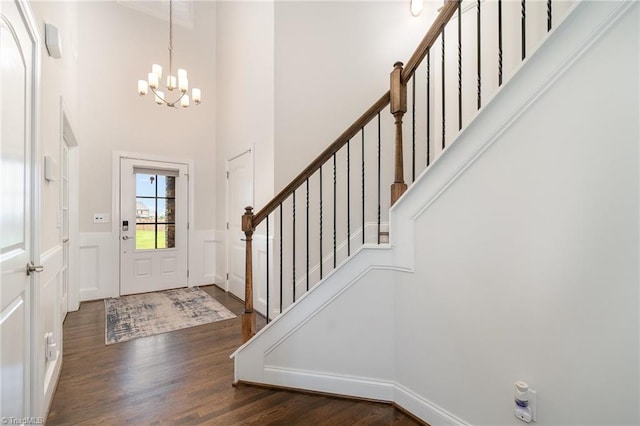 6006 Tanoak Ct, Stokesdale, NC 27357 - entryway with a chandelier, wood finished floors, a high ceiling, wainscoting, and stairway