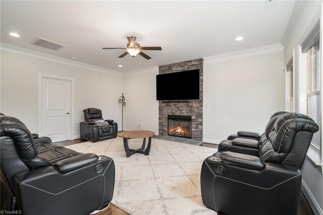 6006 Tanoak Ct, Stokesdale, NC 27357 - living room with ceiling fan, ornamental molding, a stone fireplace, and recessed lighting