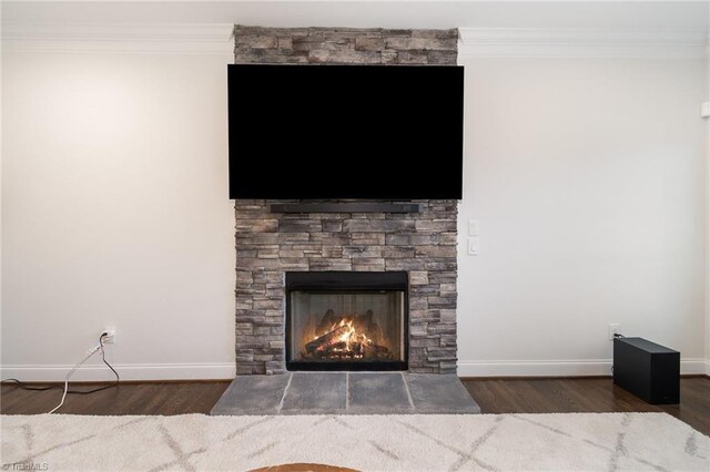 6006 Tanoak Ct, Stokesdale, NC 27357 - detailed view of wood finished floors, ornamental molding, baseboards, and a fireplace
