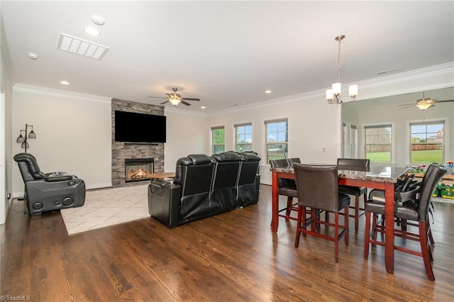 6006 Tanoak Ct, Stokesdale, NC 27357 - dining area with ceiling fan, crown molding, a fireplace, dark wood finished floors, and recessed lighting
