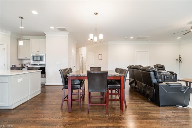 6006 Tanoak Ct, Stokesdale, NC 27357 - dining space with crown molding, dark wood-style floors, a chandelier, recessed lighting, and a ceiling fan