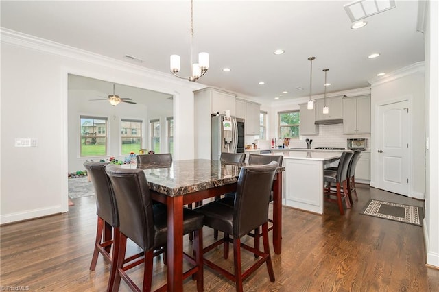 6006 Tanoak Ct, Stokesdale, NC 27357 - dining space with crown molding, recessed lighting, dark wood-style flooring, baseboards, and a chandelier