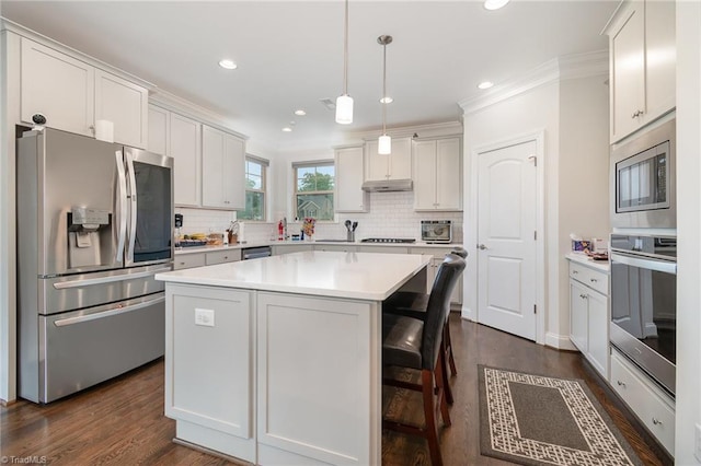 6006 Tanoak Ct, Stokesdale, NC 27357 - kitchen featuring stainless steel appliances, dark wood-style flooring, tasteful backsplash, crown molding, and light countertops