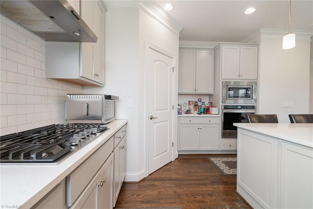 6006 Tanoak Ct, Stokesdale, NC 27357 - kitchen with stainless steel appliances, under cabinet range hood, light countertops, recessed lighting, and tasteful backsplash