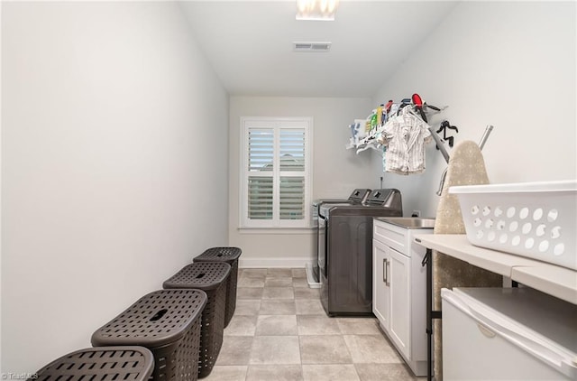 6006 Tanoak Ct, Stokesdale, NC 27357 - laundry area featuring independent washer and dryer, cabinet space, and baseboards