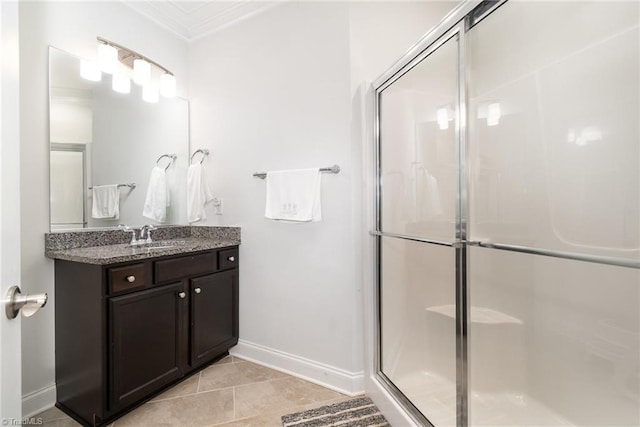 6006 Tanoak Ct, Stokesdale, NC 27357 - bathroom featuring baseboards, a stall shower, ornamental molding, vanity, and tile patterned floors