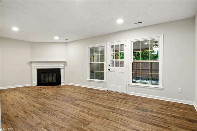 3985 Valley Ct Unit B, Winston-Salem, NC 27106 - unfurnished living room featuring wood finished floors, baseboards, recessed lighting, and a fireplace with flush hearth