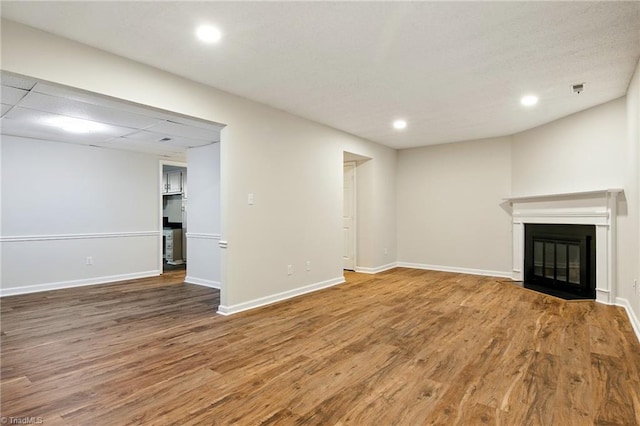 3985 Valley Ct Unit B, Winston-Salem, NC 27106 - unfurnished living room with wood finished floors, a glass covered fireplace, recessed lighting, and baseboards
