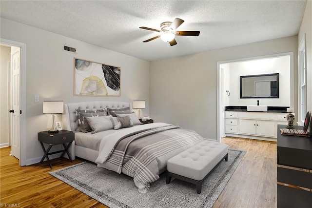 3985 Valley Ct Unit B, Winston-Salem, NC 27106 - bedroom featuring light wood finished floors, a textured ceiling, ceiling fan, and baseboards