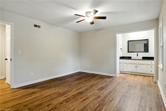 3985 Valley Ct Unit B, Winston-Salem, NC 27106 - unfurnished bedroom with wood finished floors, a textured ceiling, baseboards, and a ceiling fan