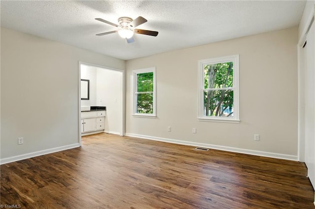 3985 Valley Ct Unit B, Winston-Salem, NC 27106 - unfurnished bedroom featuring multiple windows, wood finished floors, baseboards, and a textured ceiling