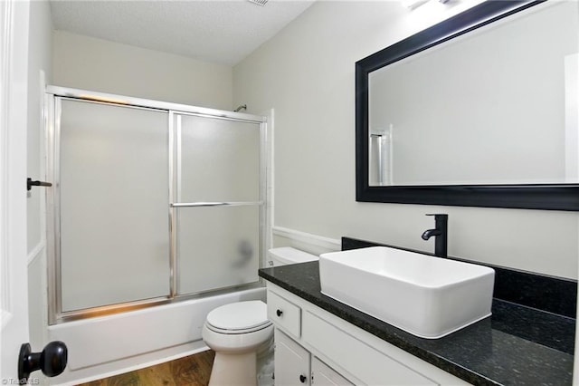 3985 Valley Ct Unit B, Winston-Salem, NC 27106 - full bathroom featuring vanity, toilet, bath / shower combo with glass door, and wood finished floors