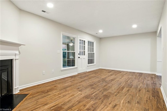 3985 Valley Ct Unit B, Winston-Salem, NC 27106 - unfurnished living room featuring a fireplace with flush hearth, wood finished floors, baseboards, and recessed lighting