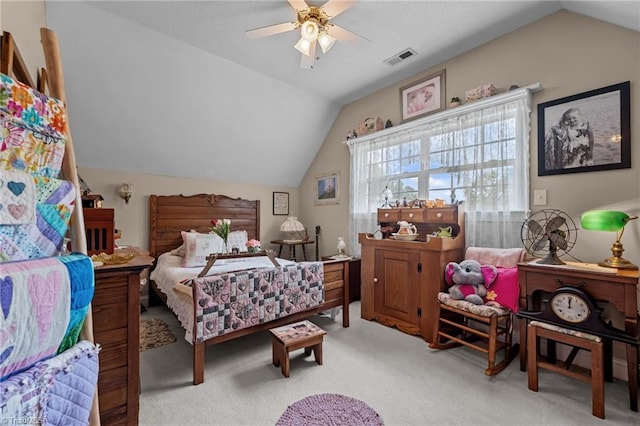 bedroom with vaulted ceiling, carpet floors, and a ceiling fan