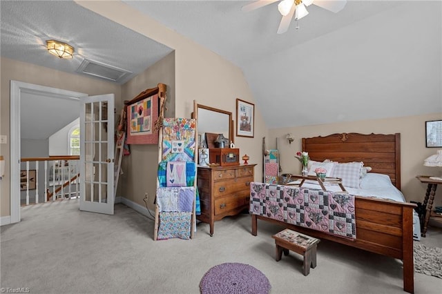 carpeted bedroom featuring vaulted ceiling, baseboards, ceiling fan, and attic access