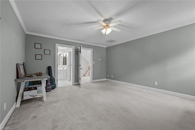 unfurnished bedroom featuring a textured ceiling, crown molding, light colored carpet, a ceiling fan, and baseboards