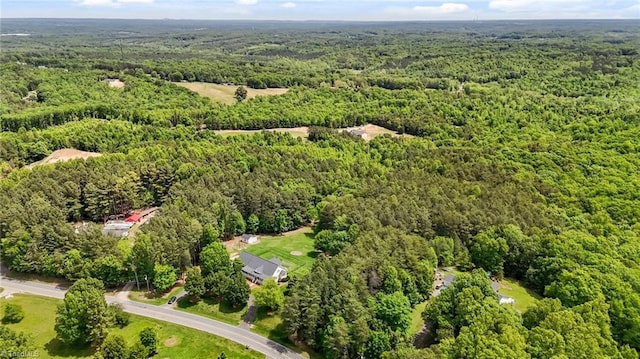 aerial overview of property's location with a heavily wooded area
