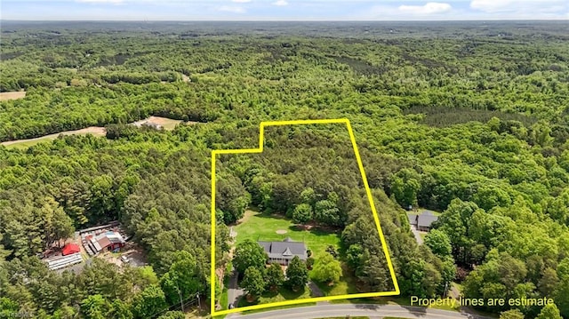 aerial overview of property's location with a forest and property parcel outlined